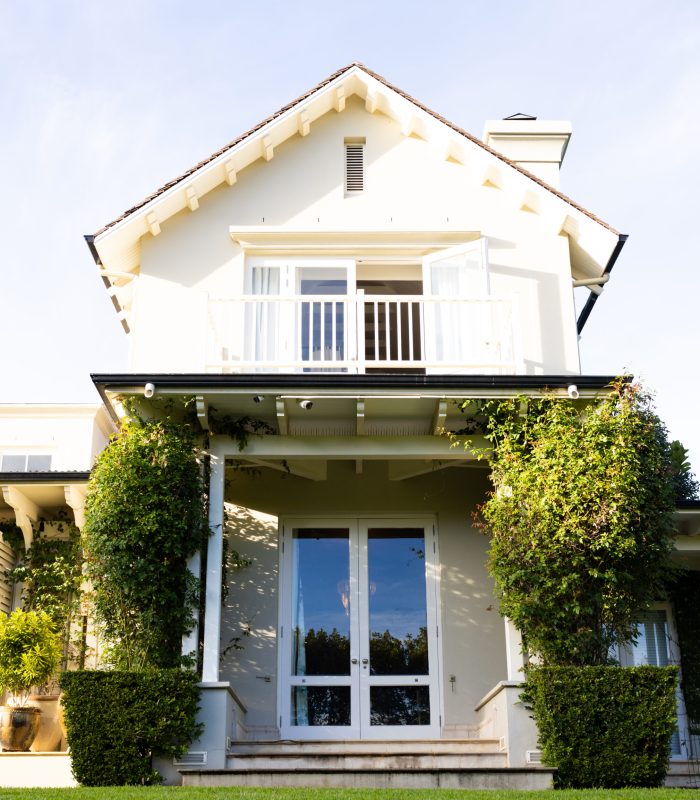 Modern house with white facade and greenery, showcasing beautiful architecture. exterior, contemporary, design, landscaping