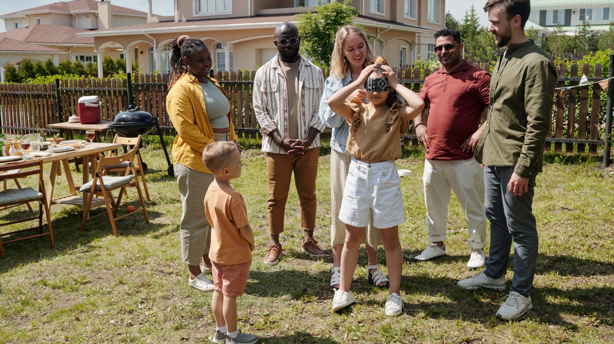 young-woman-blindfolding-little-daughter-while-play